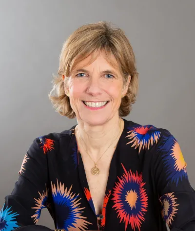 A headshot of Jane smiling at the camera