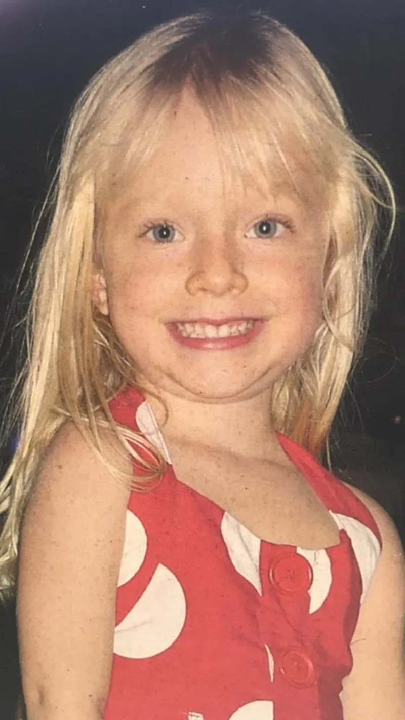 Picture of Georgia smiling and wearing a red dress