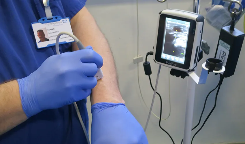 Picture of a nurse with gloves demonstrating ultrasound