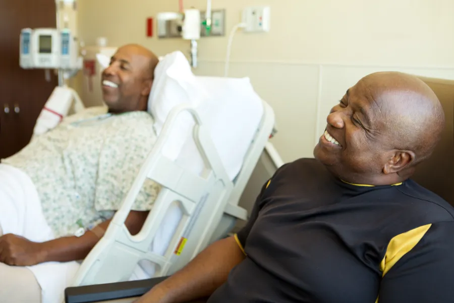 Two men talking and smiling