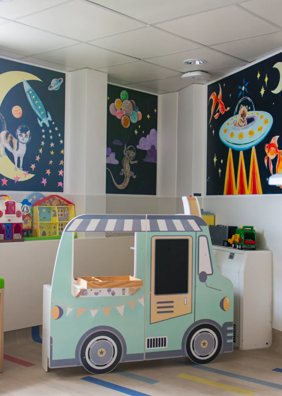 A fun car for children to play in with space murals around the outside