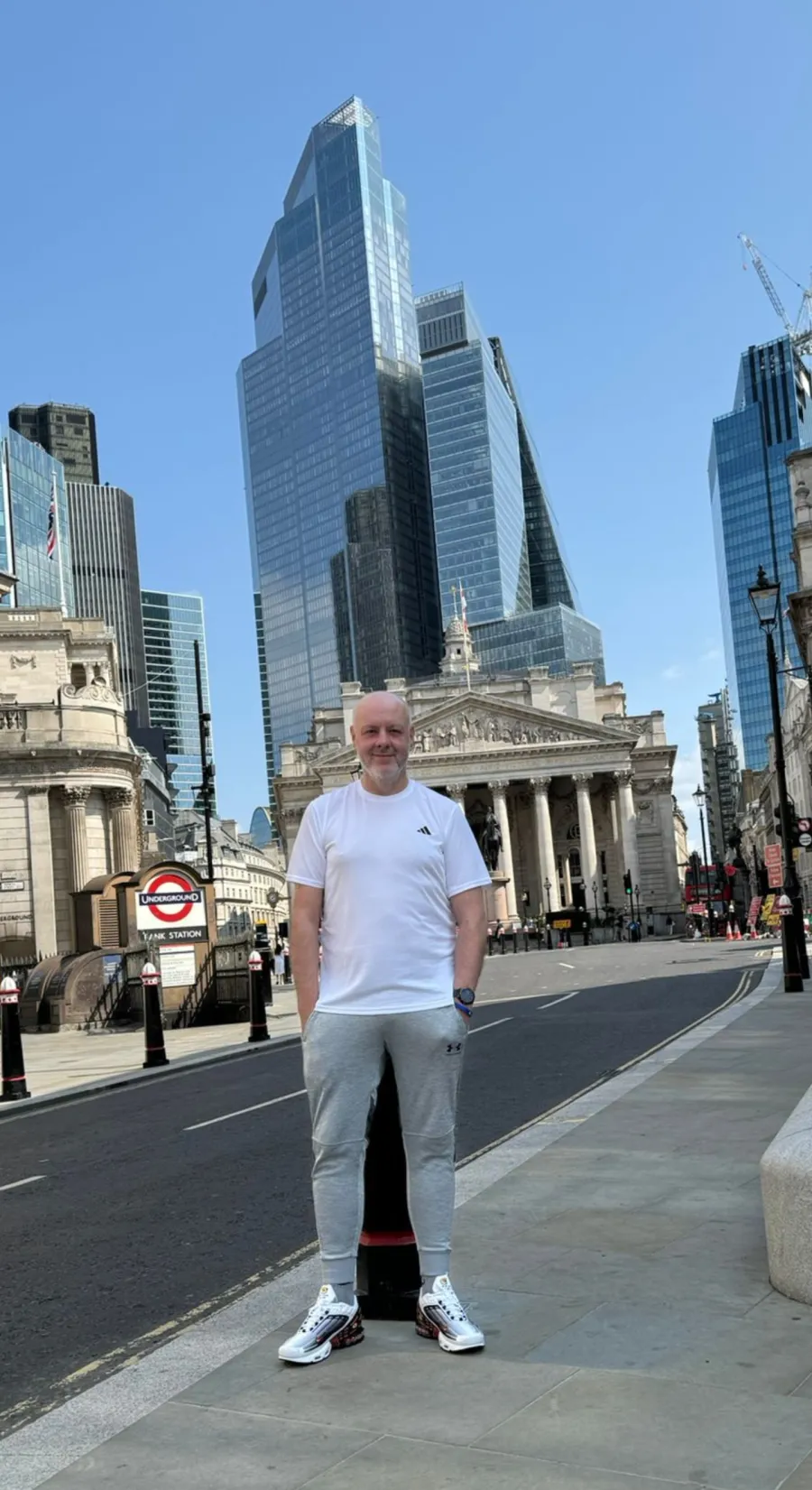 Man standing in London with Bank of England in the background