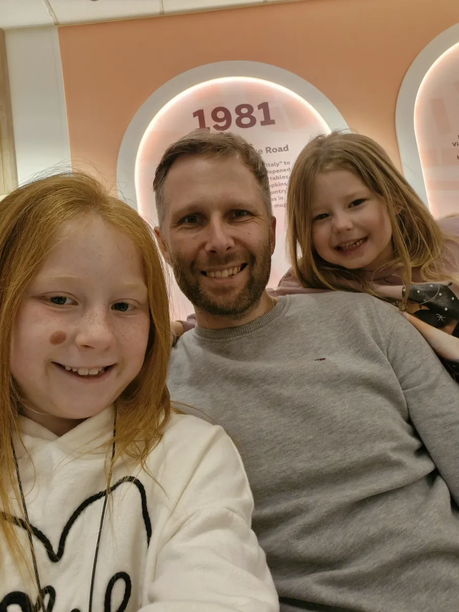 David smiling with his two daughters