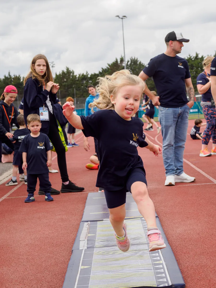 A small child doing long jump 