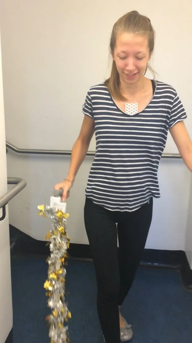Helen practising walking holding tinsel