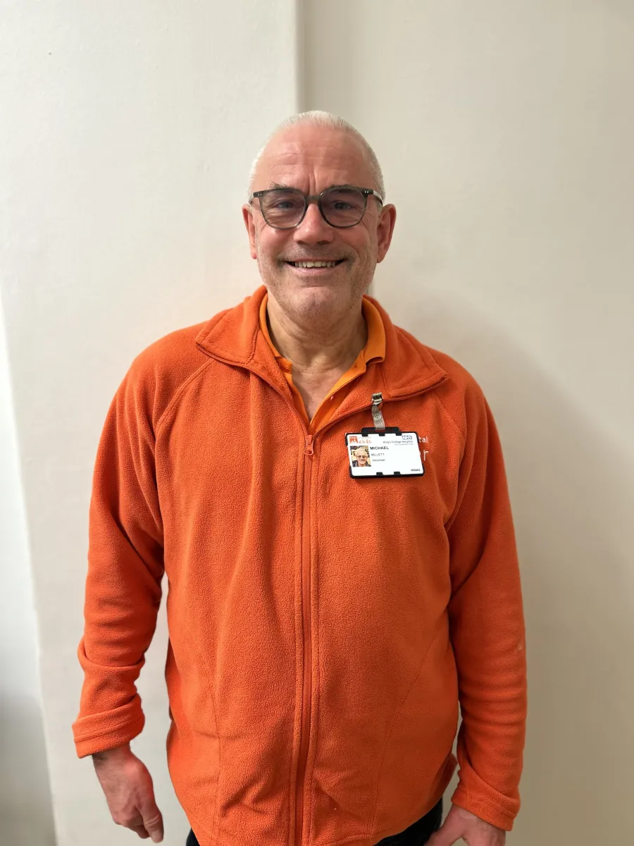 A volunteer dressed in bright orange