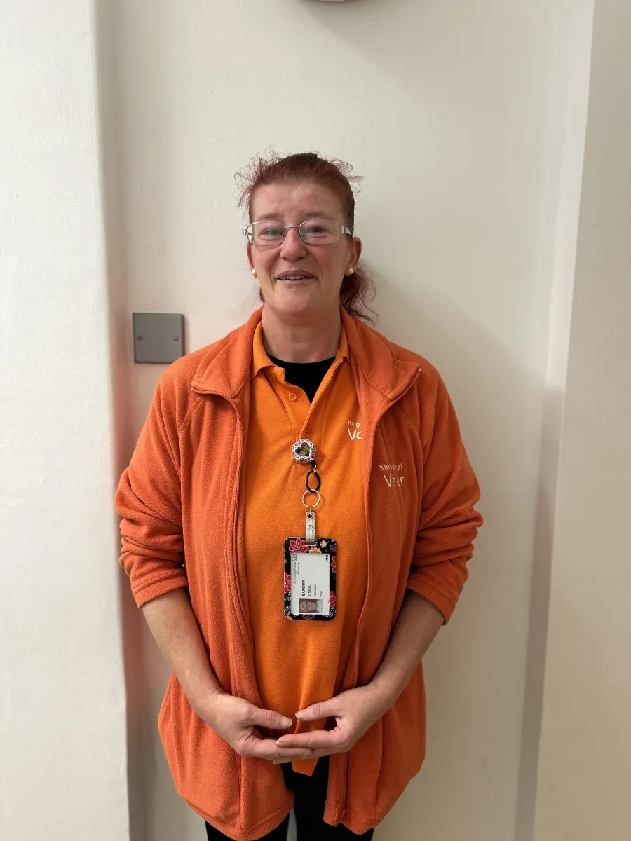 A volunteer dressed in bright orange