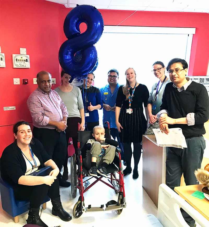 Photo of Liam with his family and hospital staff at his 8th birthday party