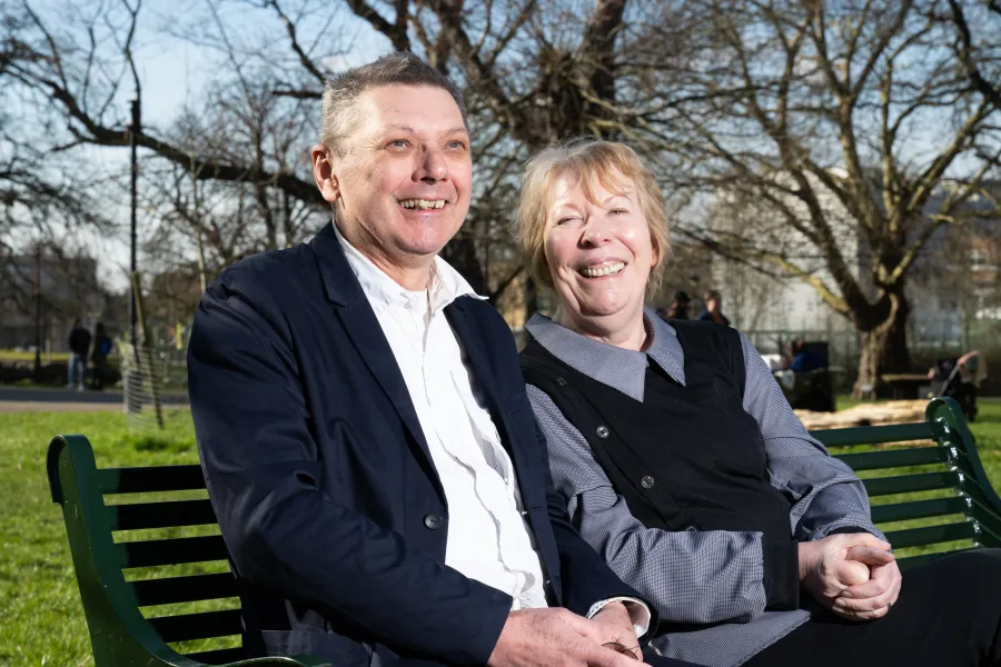 Barbara and Duncan sat on a bench smiling