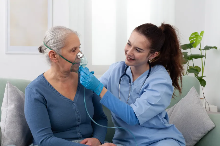 A doctor giving oxygen to a patient in their home