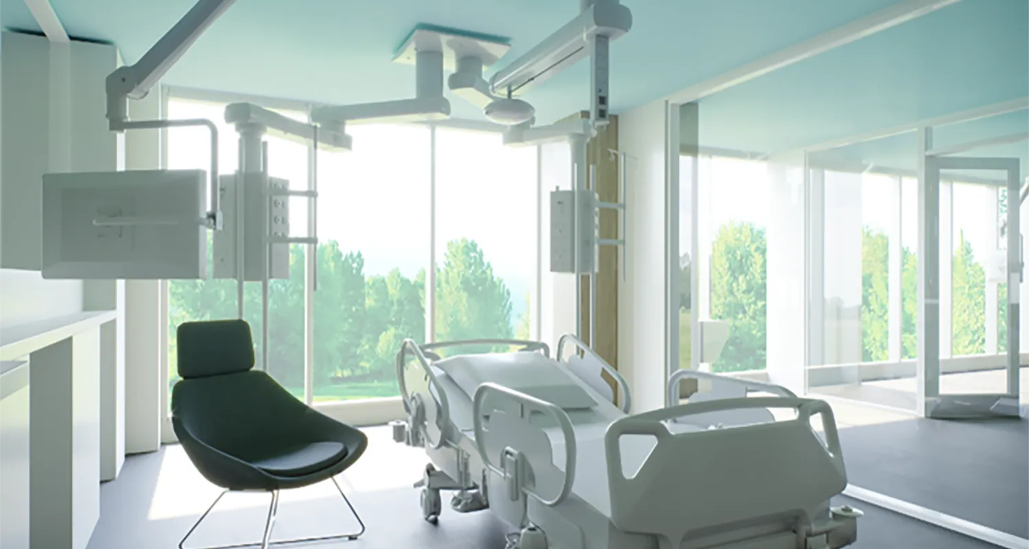 The new Critical Care Unit. It is a brightly lit patient bedroom with a view of Ruskin Park and many trees in the background. There is a clinical bed in the middle with a black visitor's chair to the left-hand side.