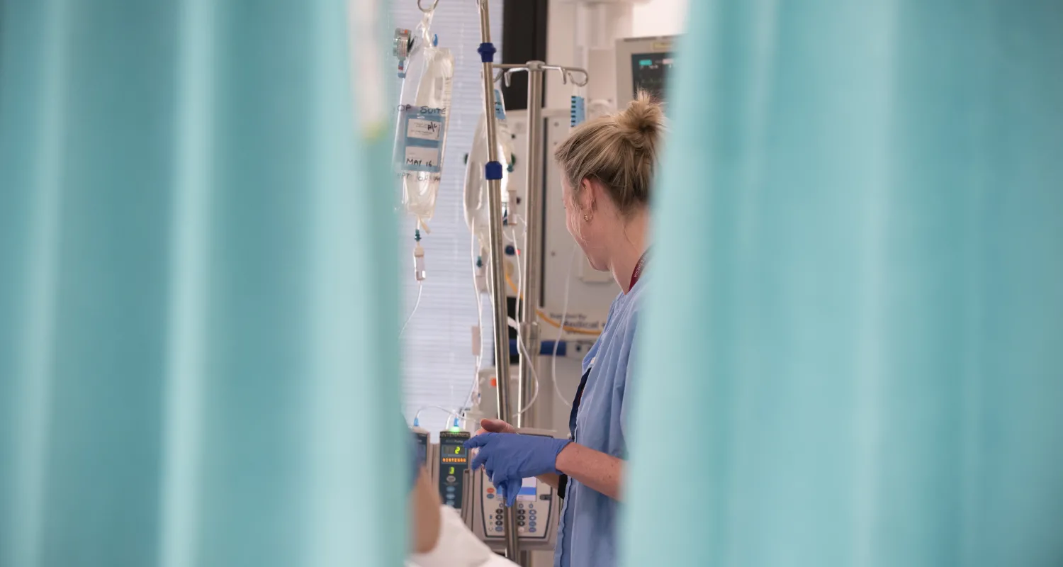 An image of a doctor and patient behind a curtain