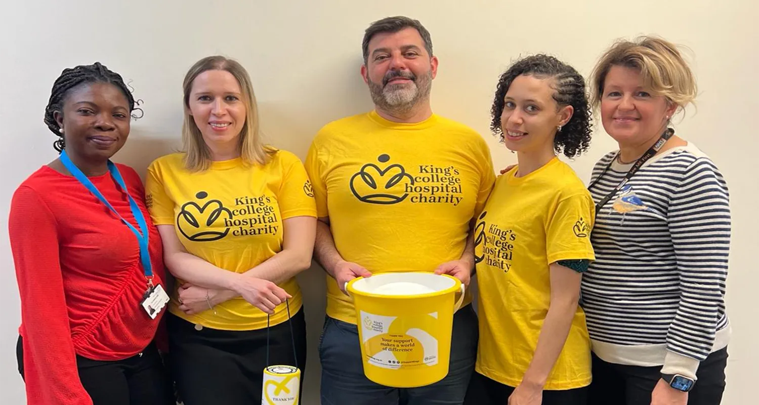 Georgios and colleagues in King's College Hospital Charity branded yellow t-shirts and holding a collection bucket