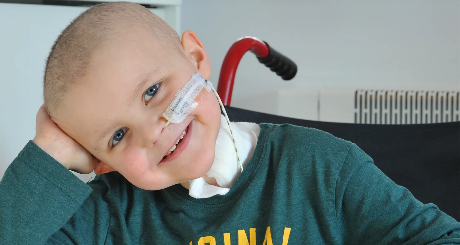 Photo of Liam leaning on his hand with nasal tube