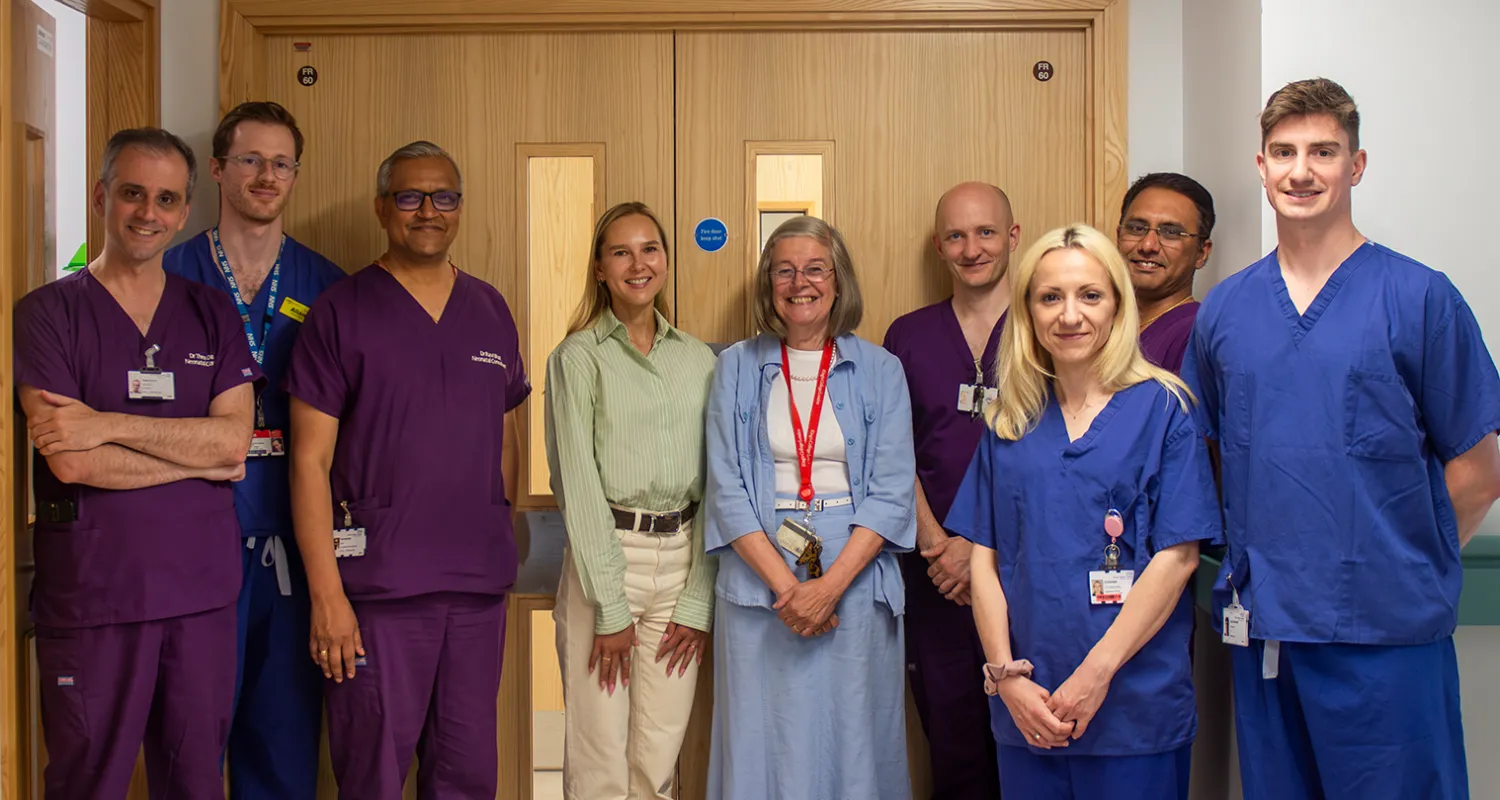 Group of clinical staff, charity representatives, and Daria Bukhman standing outside the neonatal ward at King's College Hospital