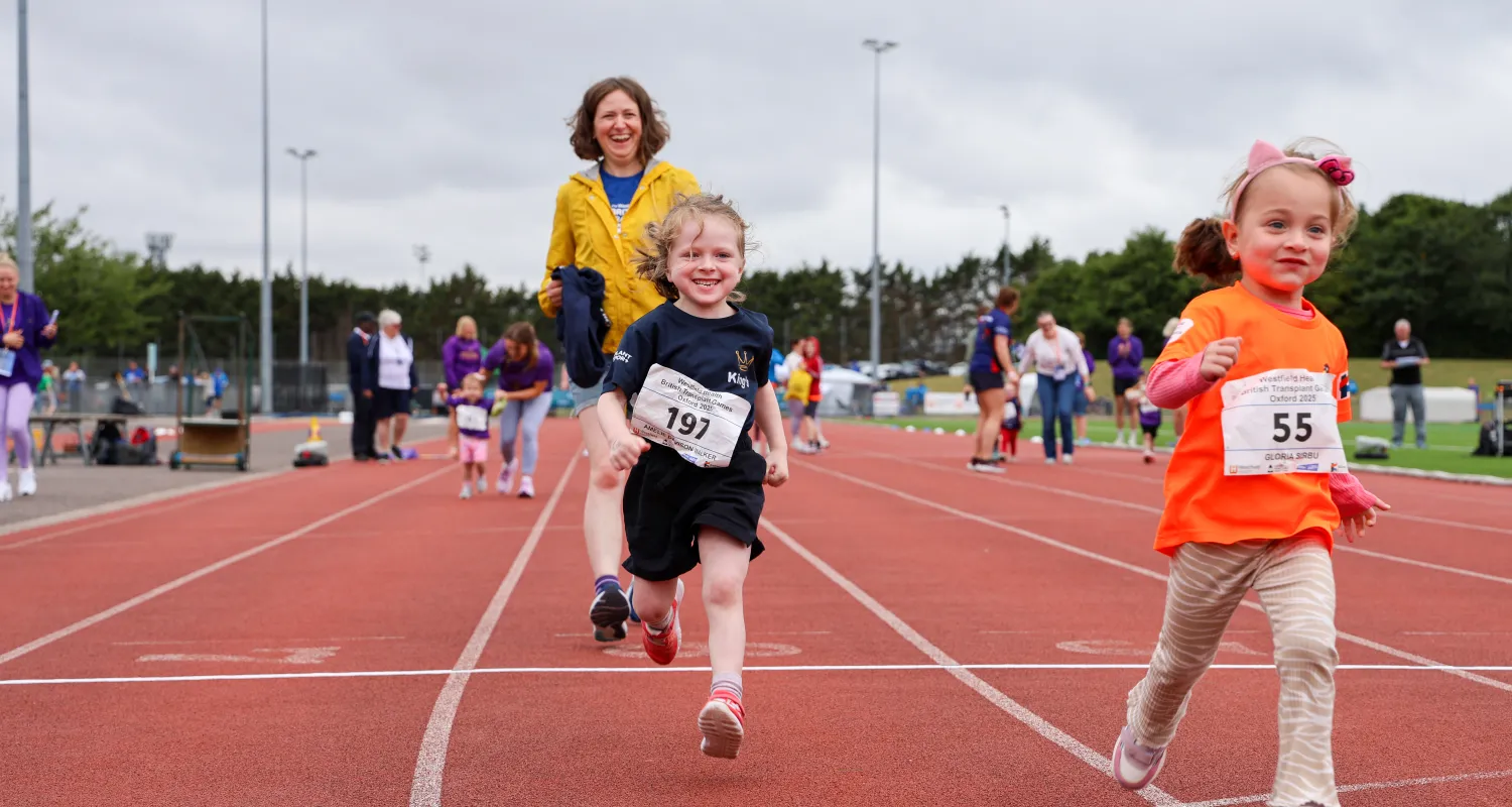 Two girls running a race on a track