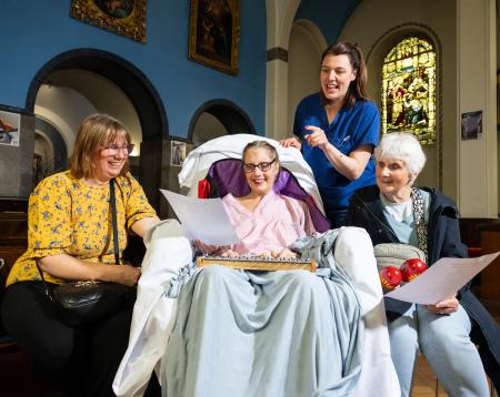 A patient singing and playing music with her family