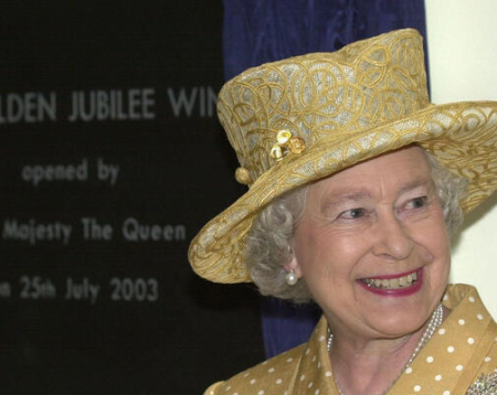 Photo of HRH Queen Elizabeth smiilng and wearing a hat at the opening of King's Golden Jubilee Wing