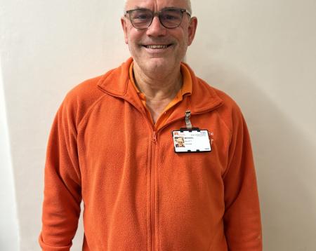 A volunteer dressed in bright orange