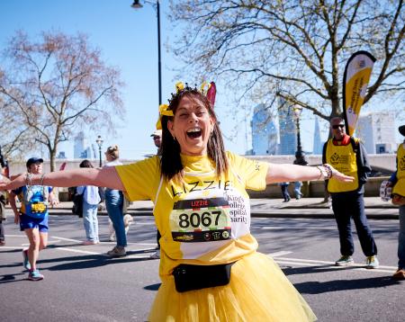 A girl called Lizzie in a yellow tutu running through London for King's College Hospital Charity