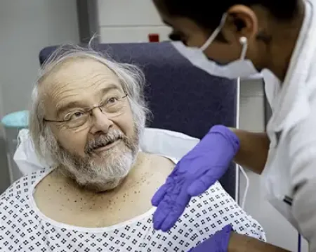 Photo of a man receiving treatment from a nurse