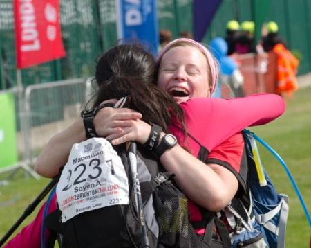 Two women embrace with big smiles