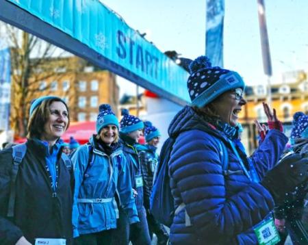 A close up shot of a group of women walking past camera wearing winter clothes