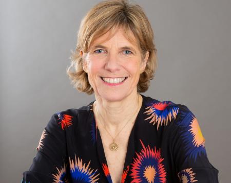 A headshot of Jane smiling at the camera