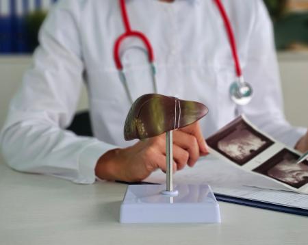 A doctor looking at liver scans 