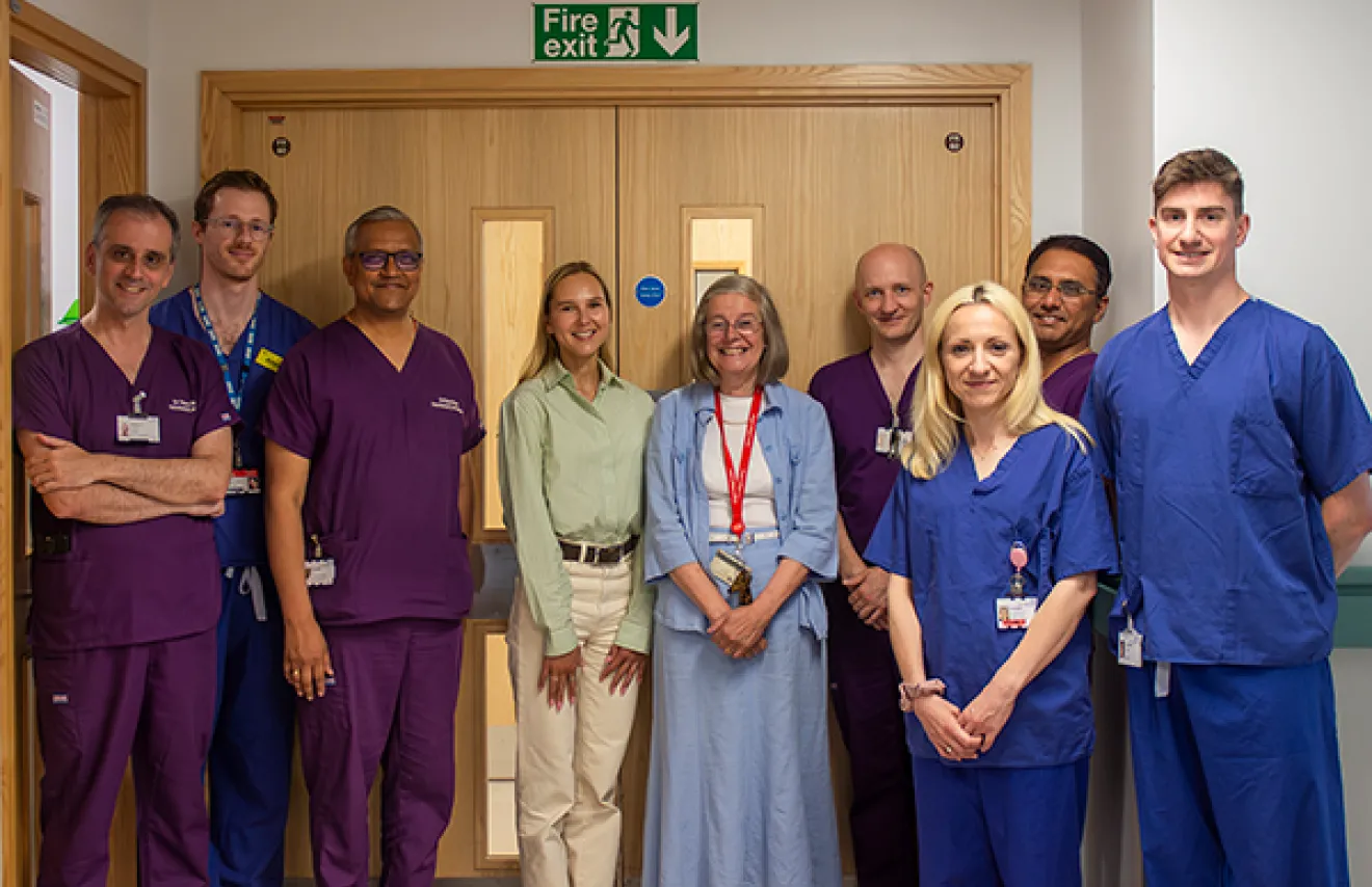 Group of clinical staff, charity representatives, and Daria Bukhman standing outside the neonatal ward