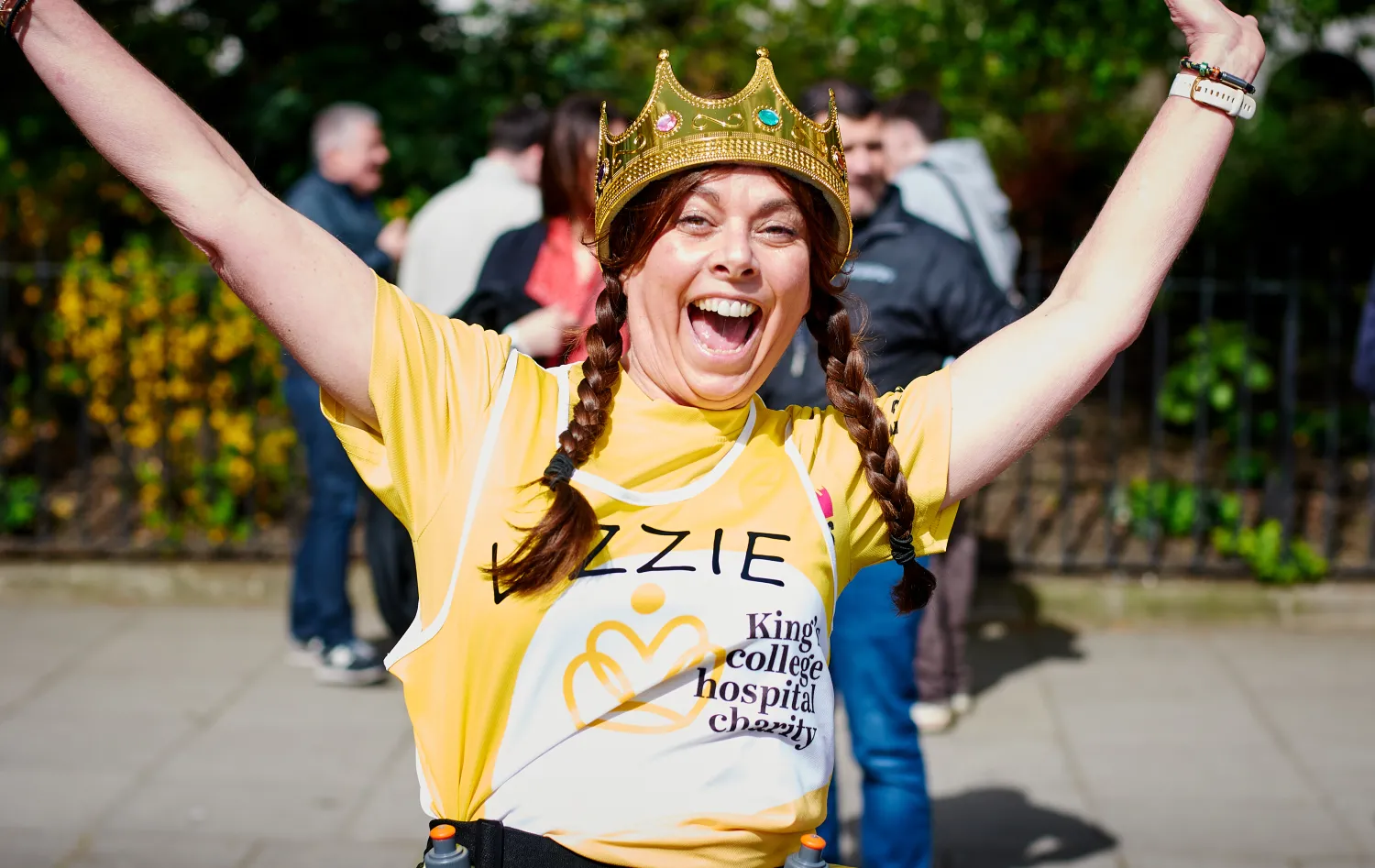 Women running in charity gear and smiling
