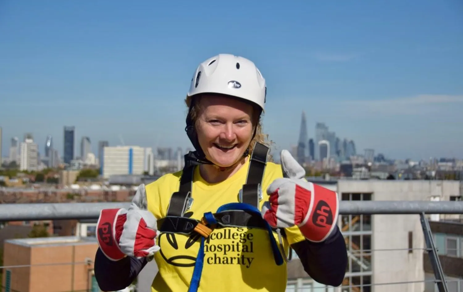 Gail with her thumbs up wearing a King's College Hospital Charity t-shirt wearing safety equipment