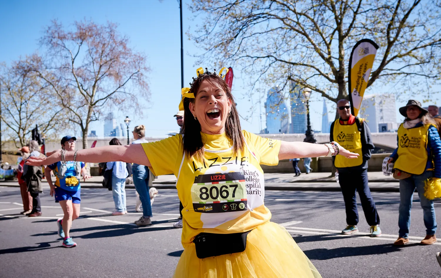 A girl called Lizzie in a yellow tutu running through London for King's College Hospital Charity