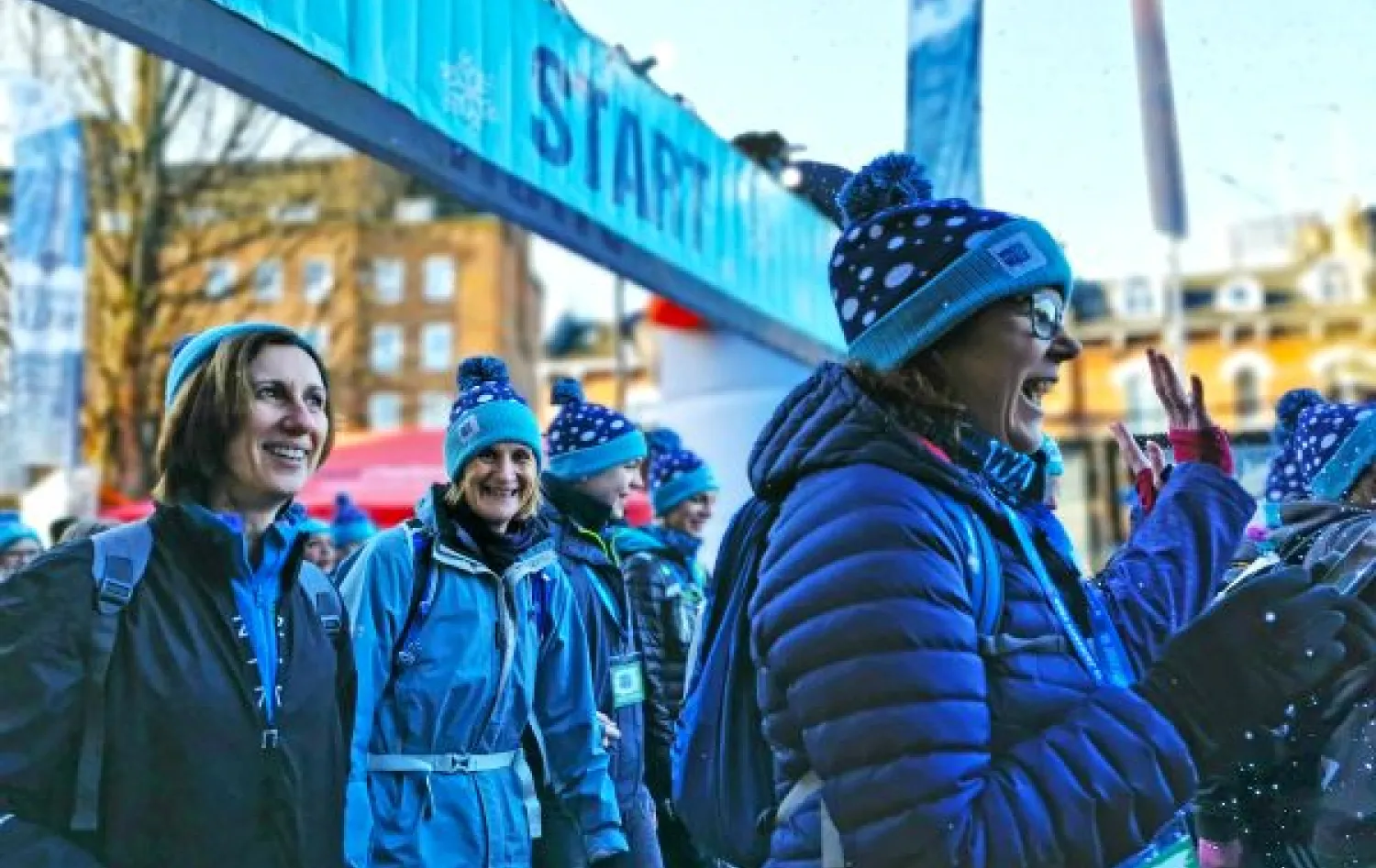 A close up shot of a group of women walking past camera wearing winter clothes