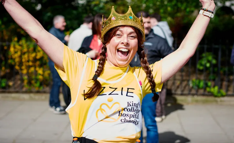 Women running in charity gear and smiling