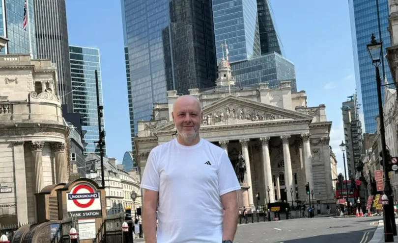 Man standing in London with Bank of England in the background