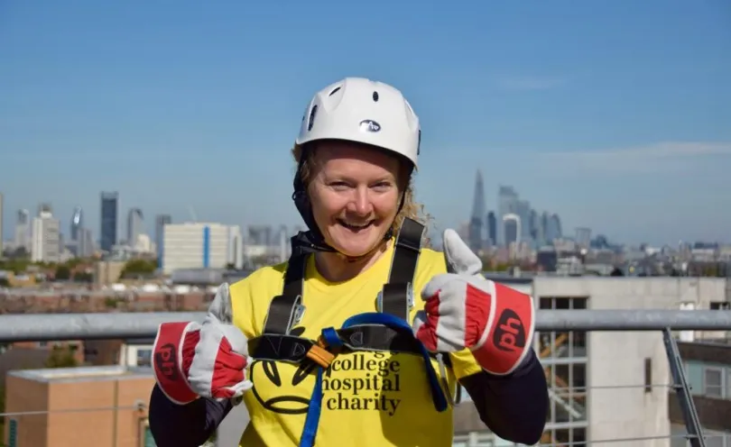 Gail with her thumbs up wearing a King's College Hospital Charity t-shirt wearing safety equipment