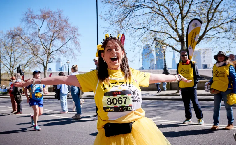 A girl called Lizzie in a yellow tutu running through London for King's College Hospital Charity