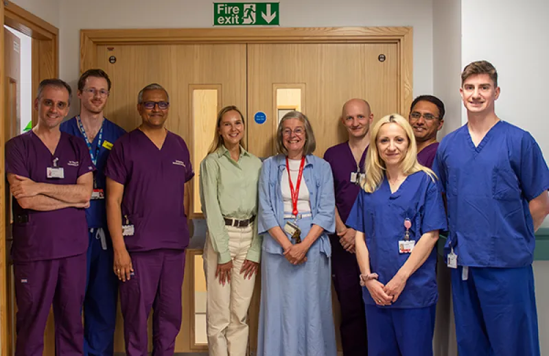 Group of clinical staff, charity representatives, and Daria Bukhman standing outside the neonatal ward
