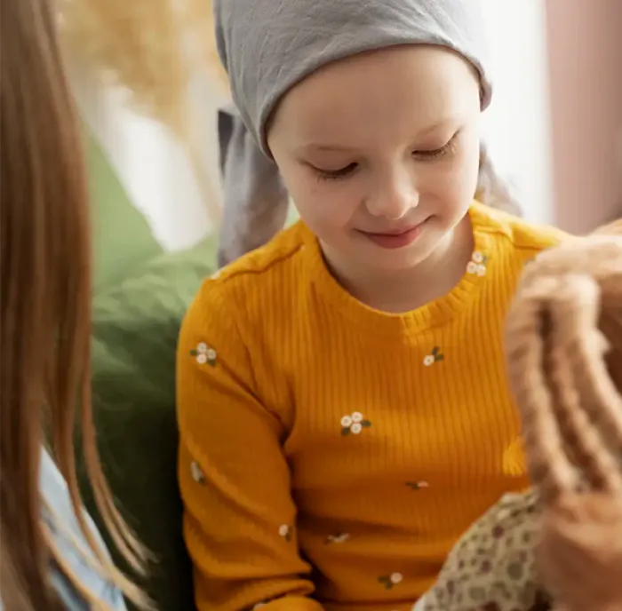 Picture of a child holding a teddy in hospital