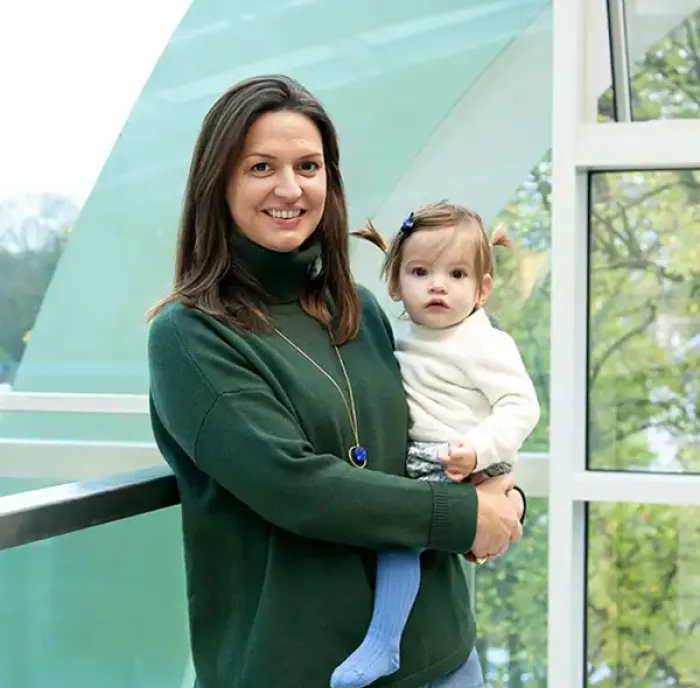 Photo of a mother holding her young child at King's