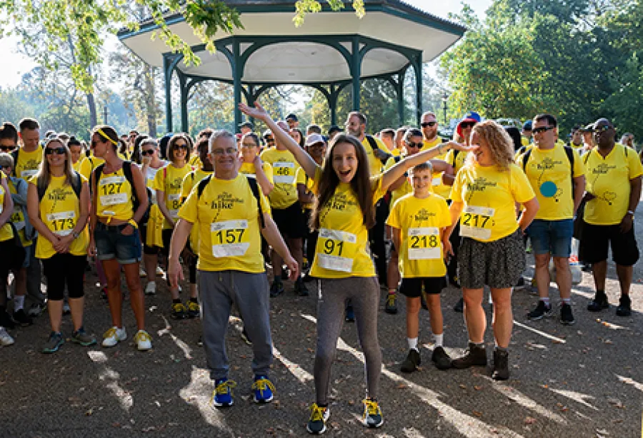 Olivia and Simon at the start line to the Great Hospital Hike with a crowd behind them