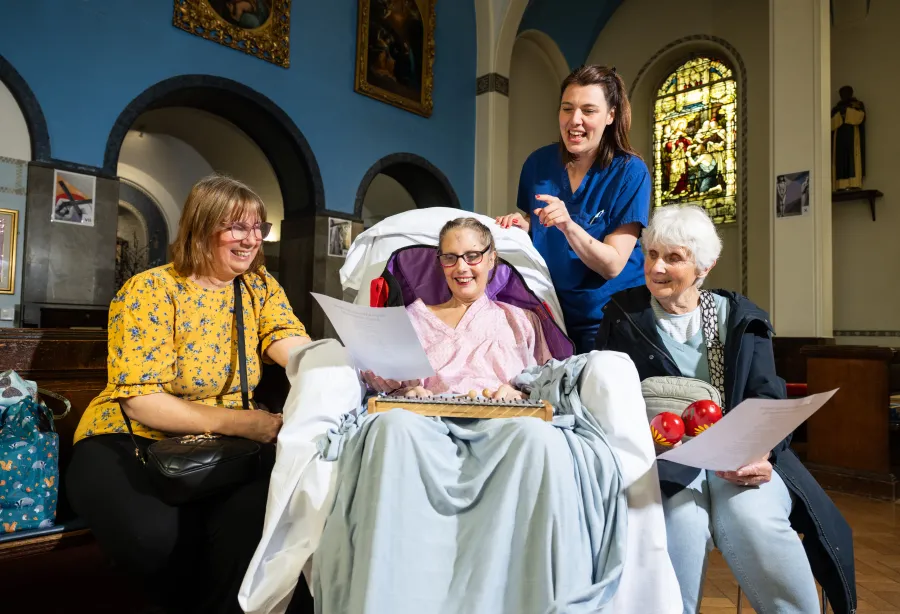 A patient singing and playing music with her family