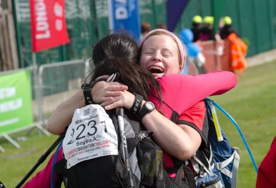 Two women embrace with big smiles
