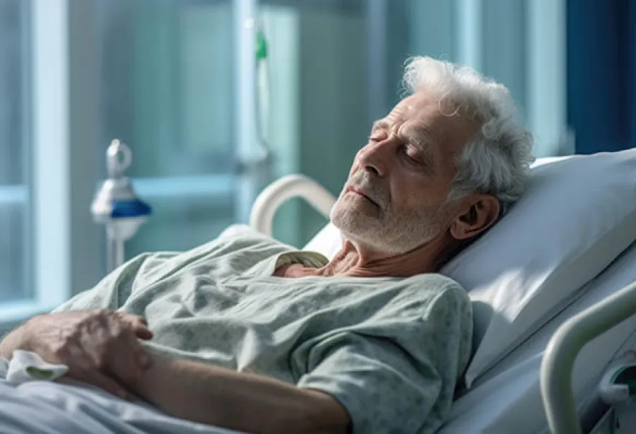 Picture of a man asleep in hospital bed