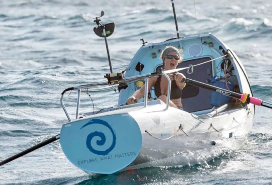 Picture of Kiko wearing sunglasses in her small, white rowing boat on her Atlantic crossing